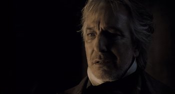 Movie still from “Sweeney Todd: The Demon Barber of Fleet Street” (2007), directed by Tim Burton – A person wearing a suit and tie; Close Up shot, Low angle