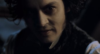 Movie still from “Sweeney Todd: The Demon Barber of Fleet Street” (2007), directed by Tim Burton – A person wearing a black shirt; Close Up shot, High angle
