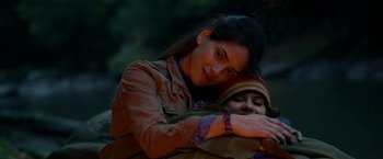 Movie still from “Sweet Girl” (2021), directed by Brian Andrew Mendoza – A woman holding a child in her arms; Close Up shot, Over the shoulder angle