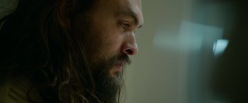 Movie still from “Sweet Girl” (2021), directed by Brian Andrew Mendoza – A person with long hair and a beard; Close Up shot, Low angle