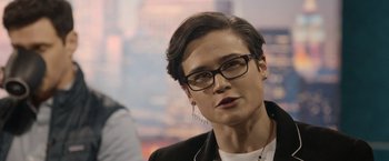 Movie still from “Sweet Girl” (2021), directed by Brian Andrew Mendoza – A woman wearing glasses and a black jacket; Close Up shot, Over the shoulder angle