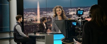 Movie still from “Sweet Girl” (2021), directed by Brian Andrew Mendoza – A woman is standing in front of a television screen; Medium shot, Over the shoulder angle