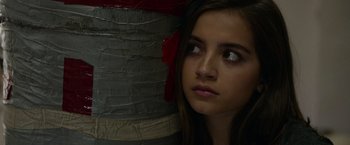 Movie still from “Sweet Girl” (2021), directed by Brian Andrew Mendoza – A young girl looking to her left with a serious look on her face; Close Up shot, Low angle