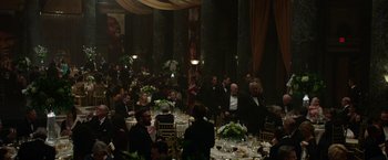 Movie still from “Sweet Girl” (2021), directed by Brian Andrew Mendoza – A group of people sitting at tables in a room; Extreme Wide shot, High angle