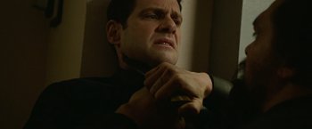 Movie still from “Sweet Girl” (2021), directed by Brian Andrew Mendoza – A person holding his hands on his neck; Close Up shot, High angle