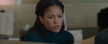 Movie still from “Sweet Girl” (2021), directed by Brian Andrew Mendoza – A person wearing a green shirt; Close Up shot, Over the shoulder angle