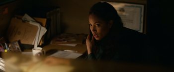 Movie still from “Sweet Girl” (2021), directed by Brian Andrew Mendoza – A woman sitting at a table talking on a phone; Close Up shot, Over the shoulder angle
