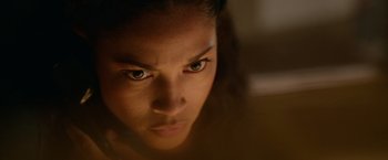 Movie still from “Sweet Girl” (2021), directed by Brian Andrew Mendoza – A woman's face in the dark; Extreme Close Up shot, High angle