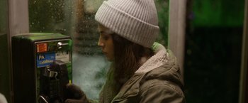 Movie still from “Sweet Girl” (2021), directed by Brian Andrew Mendoza – A woman wearing a white hat looking out of a window; Close Up shot, Over the shoulder angle