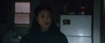 Movie still from “Sweet Girl” (2021), directed by Brian Andrew Mendoza – A young woman with long black hair looking at the camera; Close Up shot, Over the shoulder angle