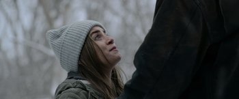 Movie still from “Sweet Girl” (2021), directed by Brian Andrew Mendoza – A woman in a white hat looking up into the sky; Close Up shot, Over the shoulder angle