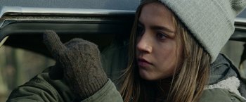 Movie still from “Sweet Girl” (2021), directed by Brian Andrew Mendoza – A woman sitting in the back seat of a car looking sad; Close Up shot, Low angle