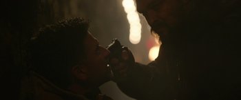 Movie still from “Sweet Girl” (2021), directed by Brian Andrew Mendoza – A man with a beard is getting his face brushed by another man; Close Up shot, Over the shoulder angle