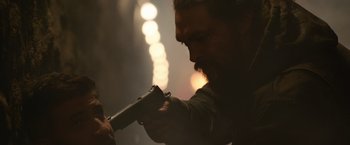 Movie still from “Sweet Girl” (2021), directed by Brian Andrew Mendoza – A man holding a gun in his hands; Close Up shot, Over the shoulder angle
