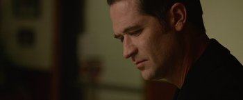 Movie still from “Sweet Girl” (2021), directed by Brian Andrew Mendoza – A man's face looking to his left; Close Up shot, Over the shoulder angle