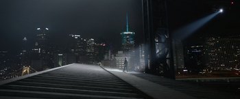 Movie still from “Sweet Girl” (2021), directed by Brian Andrew Mendoza – A person is walking on a bridge at night; Extreme Wide shot, High angle
