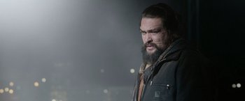 Movie still from “Sweet Girl” (2021), directed by Brian Andrew Mendoza – A man with a long beard is standing outside; Close Up shot, Low angle