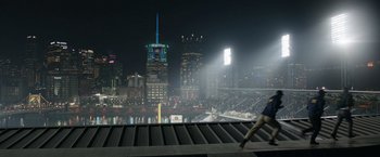Movie still from “Sweet Girl” (2021), directed by Brian Andrew Mendoza – A view of a baseball stadium at night with the lights on; Extreme Wide shot, High angle