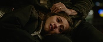 Movie still from “Sweet Girl” (2021), directed by Brian Andrew Mendoza – A person laying on the ground; Close Up shot, Overhead angle