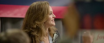 Movie still from “Sweet Girl” (2021), directed by Brian Andrew Mendoza – A person speaking on a microphone; Close Up shot, Over the shoulder angle