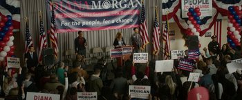 Movie still from “Sweet Girl” (2021), directed by Brian Andrew Mendoza – A group of people sitting in front of a microphone; Wide shot, High angle