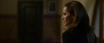 Movie still from “Sweet Girl” (2021), directed by Brian Andrew Mendoza – A person with long brown hair; Close Up shot, Over the shoulder angle