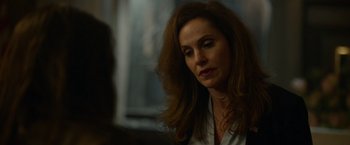 Movie still from “Sweet Girl” (2021), directed by Brian Andrew Mendoza – A person sitting in a room; Close Up shot, Over the shoulder angle