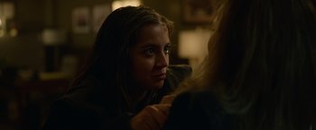 Movie still from “Sweet Girl” (2021), directed by Brian Andrew Mendoza – A young woman with a bruised face sitting at a table; Close Up shot, Over the shoulder angle