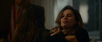 Movie still from “Sweet Girl” (2021), directed by Brian Andrew Mendoza – A woman is holding a tie around her neck; Close Up shot, Over the shoulder angle