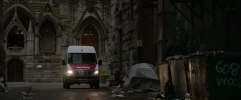 Movie still from “Sweet Girl” (2021), directed by Brian Andrew Mendoza – A van parked on the side of the road next to a tent; Extreme Wide shot, Low angle