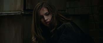 Movie still from “Sweet Girl” (2021), directed by Brian Andrew Mendoza – A young woman with a blood splatter on her forehead; Close Up shot, Over the shoulder angle