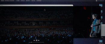 Movie still from “Tomorrow X Together: Our Lost Summer” (2023), directed by Jun-Soo Park – A crowd of people in a stadium at night with cell phones in their hands; Extreme Wide shot, High angle