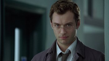 Movie still from “Closer” (2004), directed by Mike Nichols – A person wearing glasses and a jacket; Close Up shot, Low angle