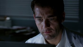 Movie still from “Closer” (2004), directed by Mike Nichols – A person looking at a computer screen; Close Up shot, Low angle