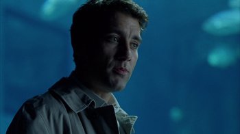 Movie still from “Closer” (2004), directed by Mike Nichols – A person wearing a shirt and tie; Close Up shot, Over the shoulder angle
