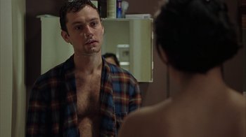 Movie still from “Closer” (2004), directed by Mike Nichols – A man looking at himself in the mirror in front of a mirror; Close Up shot, Over the shoulder angle