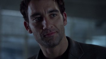 Movie still from “Closer” (2004), directed by Mike Nichols – A man's face in a dark room; Close Up shot, Over the shoulder angle