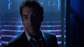 Movie still from “Closer” (2004), directed by Mike Nichols – A person wearing a suit and tie; Close Up shot, Low angle