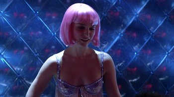 Movie still from “Closer” (2004), directed by Mike Nichols – A woman in a pink wig and a purple bra; Close Up shot, Over the shoulder angle