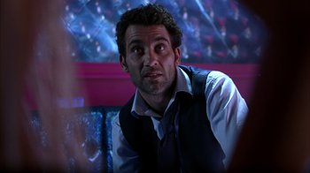 Movie still from “Closer” (2004), directed by Mike Nichols – A person wearing a vest and a tie; Close Up shot, Over the shoulder angle