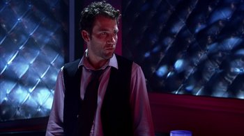 Movie still from “Closer” (2004), directed by Mike Nichols – A man wearing a vest and a neck tie; Medium shot, Over the shoulder angle