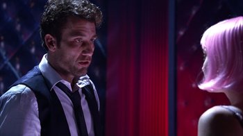 Movie still from “Closer” (2004), directed by Mike Nichols – A person wearing a suit and tie; Medium shot, Low angle