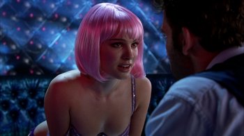Movie still from “Closer” (2004), directed by Mike Nichols – A woman in a pink wig talking to a man; Close Up shot, Over the shoulder angle