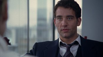Movie still from “Closer” (2004), directed by Mike Nichols – A man in a suit and a tie; Close Up shot, Over the shoulder angle