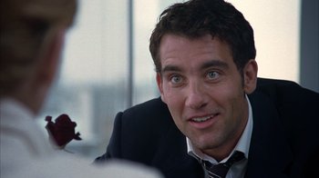 Movie still from “Closer” (2004), directed by Mike Nichols – A person wearing a suit and tie; Close Up shot, Over the shoulder angle