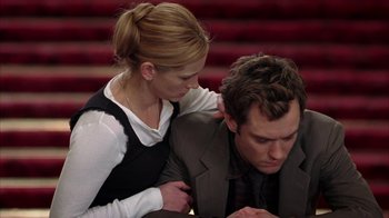 Movie still from “Closer” (2004), directed by Mike Nichols – A man and a woman sitting at a table together; Medium shot, Low angle