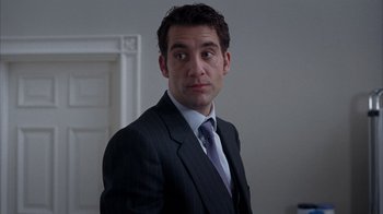Movie still from “Closer” (2004), directed by Mike Nichols – A person wearing a suit and tie; Close Up shot, Low angle