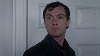 Movie still from “Closer” (2004), directed by Mike Nichols – A person wearing a suit and tie; Close Up shot, Low angle