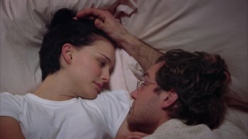 Movie still from “Closer” (2004), directed by Mike Nichols – A man and a woman laying in a bed together; Close Up shot, High angle