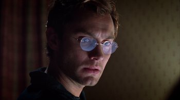 Movie still from “Closer” (2004), directed by Mike Nichols – A person wearing round glasses; Close Up shot, Low angle